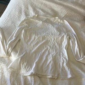 LULULEMON long sleeves white top with ruffle of back.